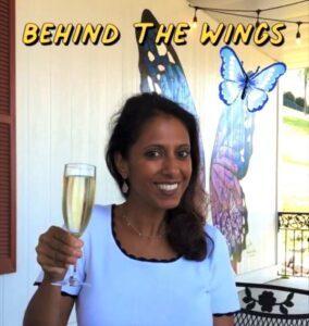 Pinkie Mistry holding a glass of wine at Hillside Winery.