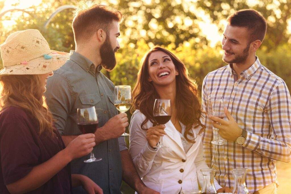 Happy friends having fun with wine